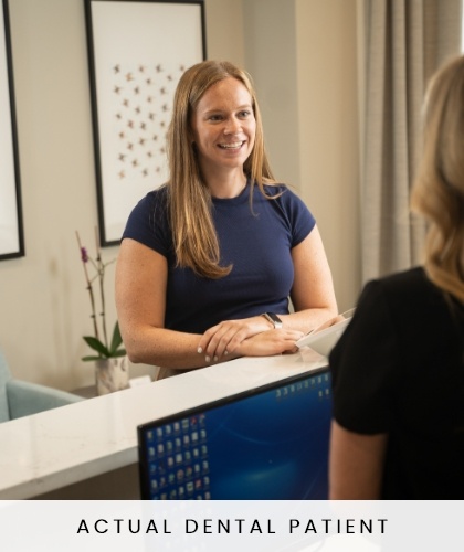 member of dental staff smiling with patient